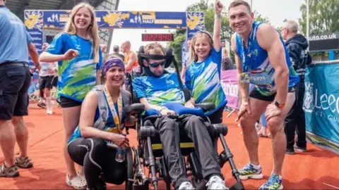 PA Rob Burrow with his family and Kevin Sinfield