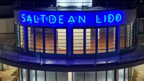 Eddie Mitchell Blue neon sign which reads Saltdean Lido