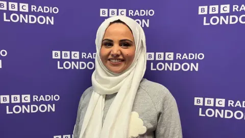 Noreen Rahman standing in the BBC Radio London studios.