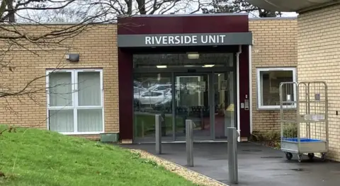The exterior of the Riverside unit in Bristol. It is a single-storey, yellow brick building.