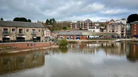 A view of Exeter quayside showing where the bridge used to be - with the Samual Jones pub on the left and the Riverside Cafe on the other side of the quay.