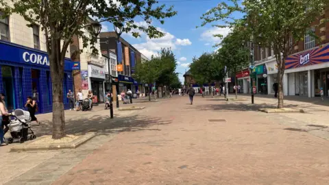 Rotherham town centre, street with shoppers walking along the pedestrian area