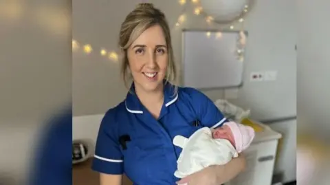 Midwife holding a newborn