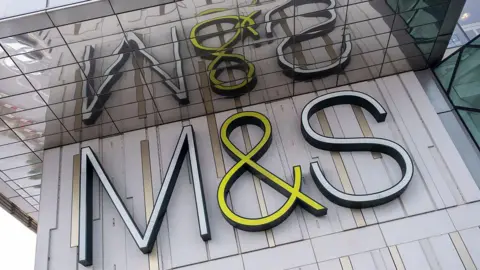 M&S sign on grey wall