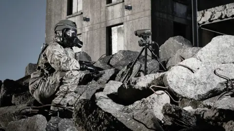 Avon Protection Image of a soldier in a war zone wearing a gas mask