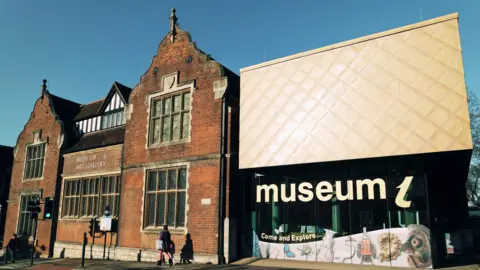 Maidstone Borough Council An old brick building with a modern extension to the right of it, with a large sign reading "museum".