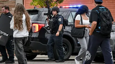 Getty Images Armed officers seen outside a library at the University of Colorado Boulder on Monday