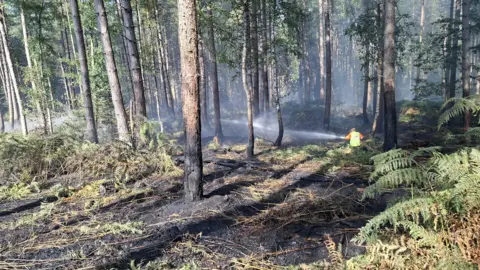Firefighter tackling a fire at Wood End Lane, in Stanton-by-Bridge, Derbyshire.