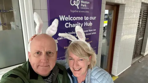 supplied A man and woman pose together both in bunny ears