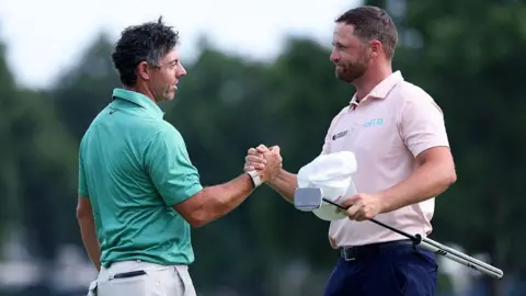 BMW Championship winner Wyndham Clark shakes hands with Rory McIlroy