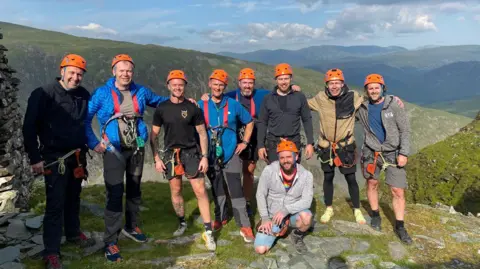 Nathan Askew Nathan and a group posing after completing the via ferrata at Honsiter Slate Mine