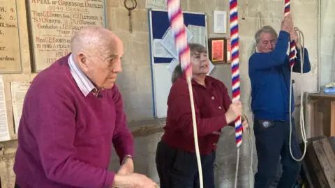 John Bennett, in the church bell tower with two fellow bell-ringers