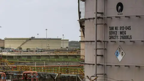 Getty Images Storage tanks at the Reliance oil refinery in Jamnagar, Gujarat, India, on Saturday, July 31, 2021. 
