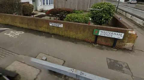 A Google Maps screen grab of a Westerham Avenue road sign against a low brick wall. The postcode reads N9.