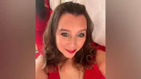 Harriet Annabelle Ward A selfie of Harriet Annabelle who is in a red top and has red lipstick on