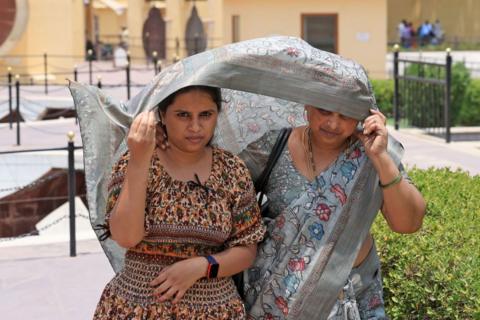 Tourists using saree for protection from the scorching sun on a hot summer day, in Jaipur, Rajasthan, India, on Wednesday, May 22, 2024.