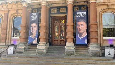Oliver Ward/BBC Ipswich Town Hall, with banners of Ipswich players either side of the entrance.