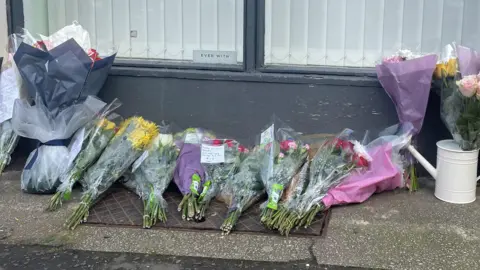 Bunches of flowers on a pavement