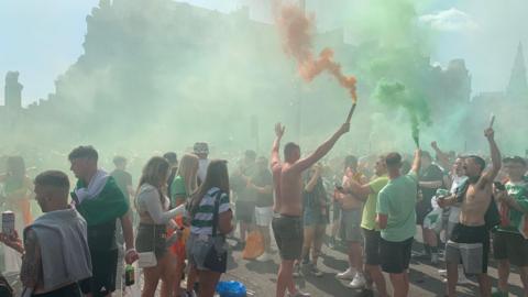 Football fans set off colour flares in Glasgow