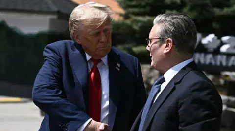 President Donald Trump and Prime Minister Keir Starmer shaking hands in suits