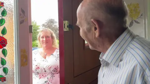 Claire meets homeowner Roger on his doorstep.
