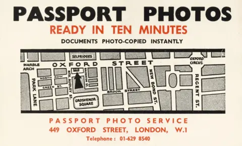 Philip Sharkey Vintage printed card advertising passport photos, featuring a simplified street map of Oxford Street. Bold text reads ‘Passport Photos Ready in Ten Minutes,’ with the address ‘449 Oxford Street, London, W1.