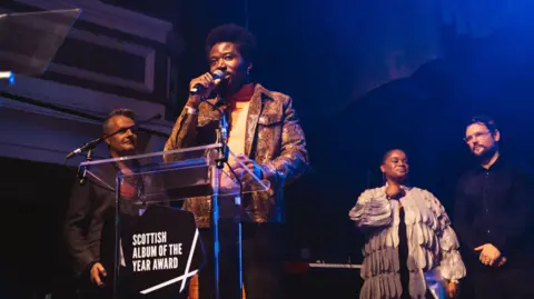 Scottish Album of the Year Alloysious Massaquoi giving an acceptance speech