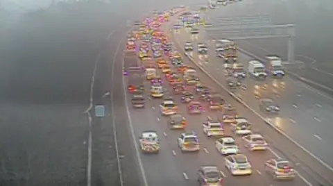 Traffic queues across four lanes of motorway.