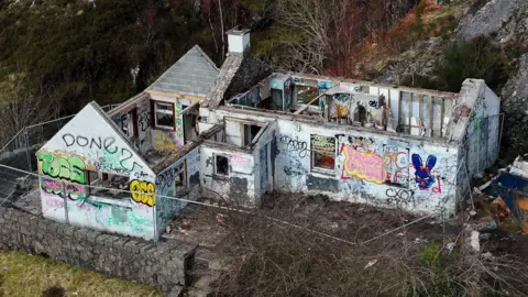 Getty Images An aerial view of the ruined, vandalised cottage showing the roof removed.