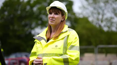 PA Media Deputy Prime Minister Angela Rayner during a visit to a new housing development, she is wearing a hi-viz jacket and a white hard hat