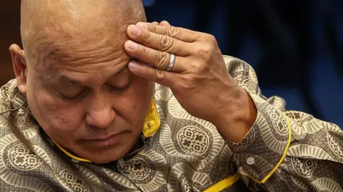 Close up image of an exasperated Philippine senator Ronald dela Rosa