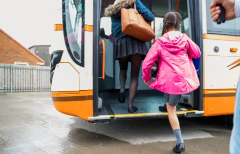 Getty Images Children getting on a bus
