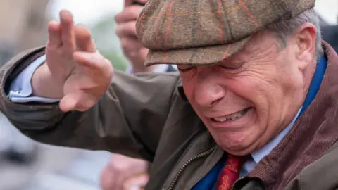 PA Nigel Farage is struck with a coffee cup during a visit to Barnsley