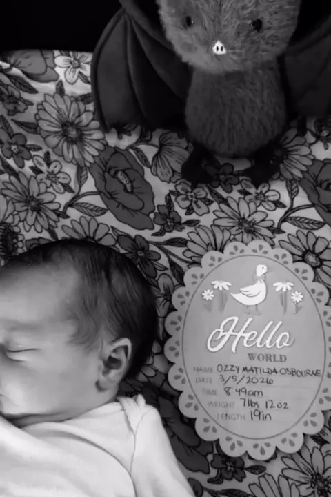 Jack Osbourne/ Instagram A picture of a baby in black and white, with a birth detail card and a small bat toy pictured.