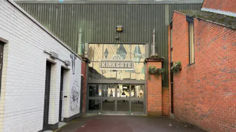 Hana Kelly/BBC The entrance to a market hall, with the word 'Kirkgate' emblazoned above the glass doors.