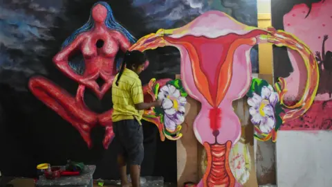 A female artist making a ''uterus'' model for a Pandal decoration, which is theme about the '' Ritumati'', social awareness about menstrual, ahead of Durga puja festival in Kolkata, India on 01 October 2023