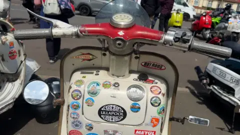 One scooter has an Ullapool sticker under the handlebars