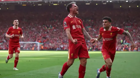 EPA Alexis Mac Allister of Liverpool celebrates with teammate Luis Diaz after scoring the second goal at Anfield on 27 April