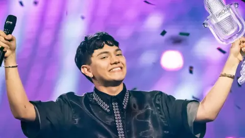 Austria's JJ celebrates with the trophy of the winner of the 69th Eurovision Song Contest