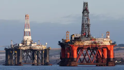 PA Media Oil platform standing amongst other rigs that have been left in the Cromarty Firth near Invergordon in the Highlands of Scotland