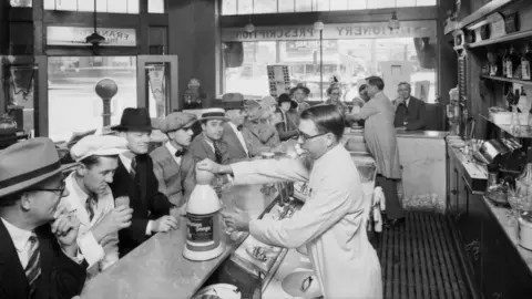 Getty Images Customers being served at a soda fountain in California in 1927