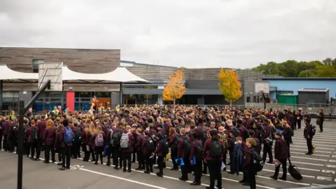 supplied An aerial shot of pupils in maroon blazers lining up in the playground.