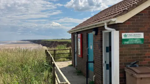 The toilet building on the clifftop at Mappleton, looking over the beach and sea