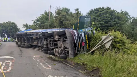 Bingham Fire Station An overturned lorry that has come off the road and landed on its side