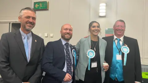 Four Reform councillors in line smiling