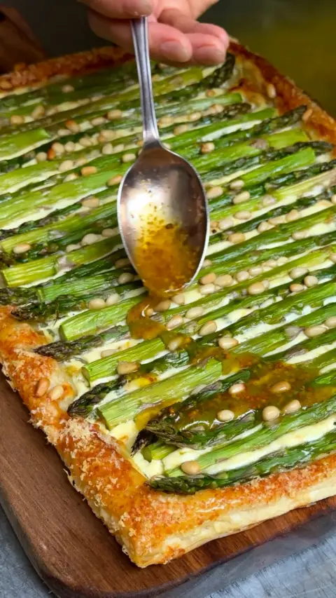 A pastry base with asparagus on top 