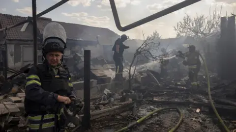 REUTERS/Thomas Peter Rescue workers extinguish a fire that destroyed a private house after a Russian attack on a residential area in Pokrovsk during the Russian attack on Ukraine, August 3, 2024