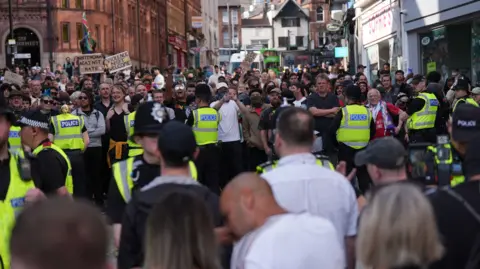 PA Media Crowds pictured at the Brian Clough statue in Nottingham