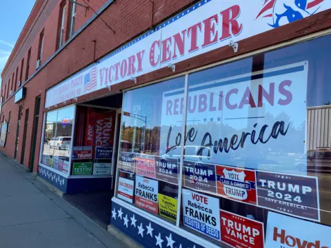 BBC / Mike Wendling A storefront office with dozens of political posters in the windows including signs for Donald Trump, a sign saying 