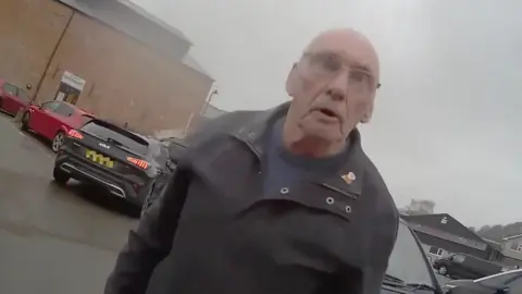 Crown Prosecution Service A man angrily looking at a person wearing body cam footage.